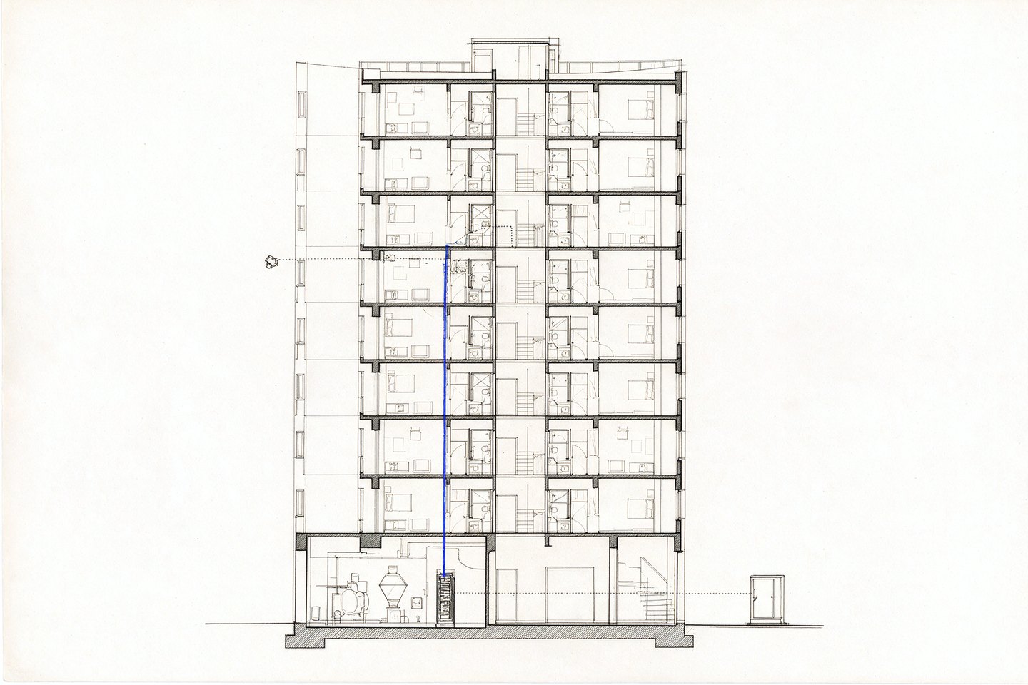 A device on a wall connects through a floor distribution point, up a service riser, into a head end in a plant room, and back to a power supply on a separate circuit.