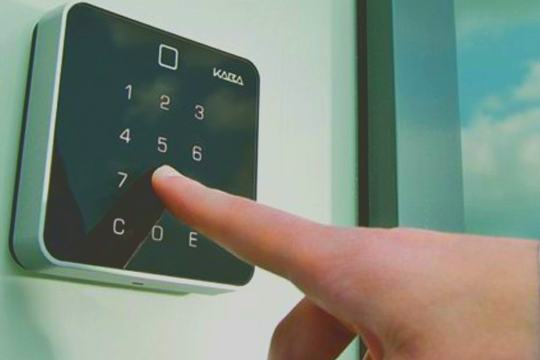 Access control reader mounted beside a controlled door