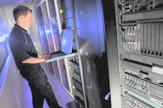 Technician servicing installed security equipment